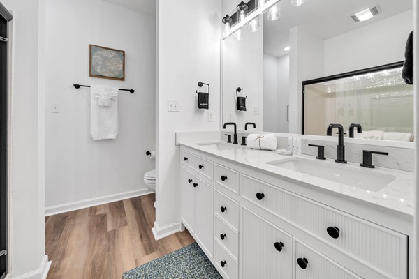 Dual sinks and ample storage in the downstairs primary bathroom