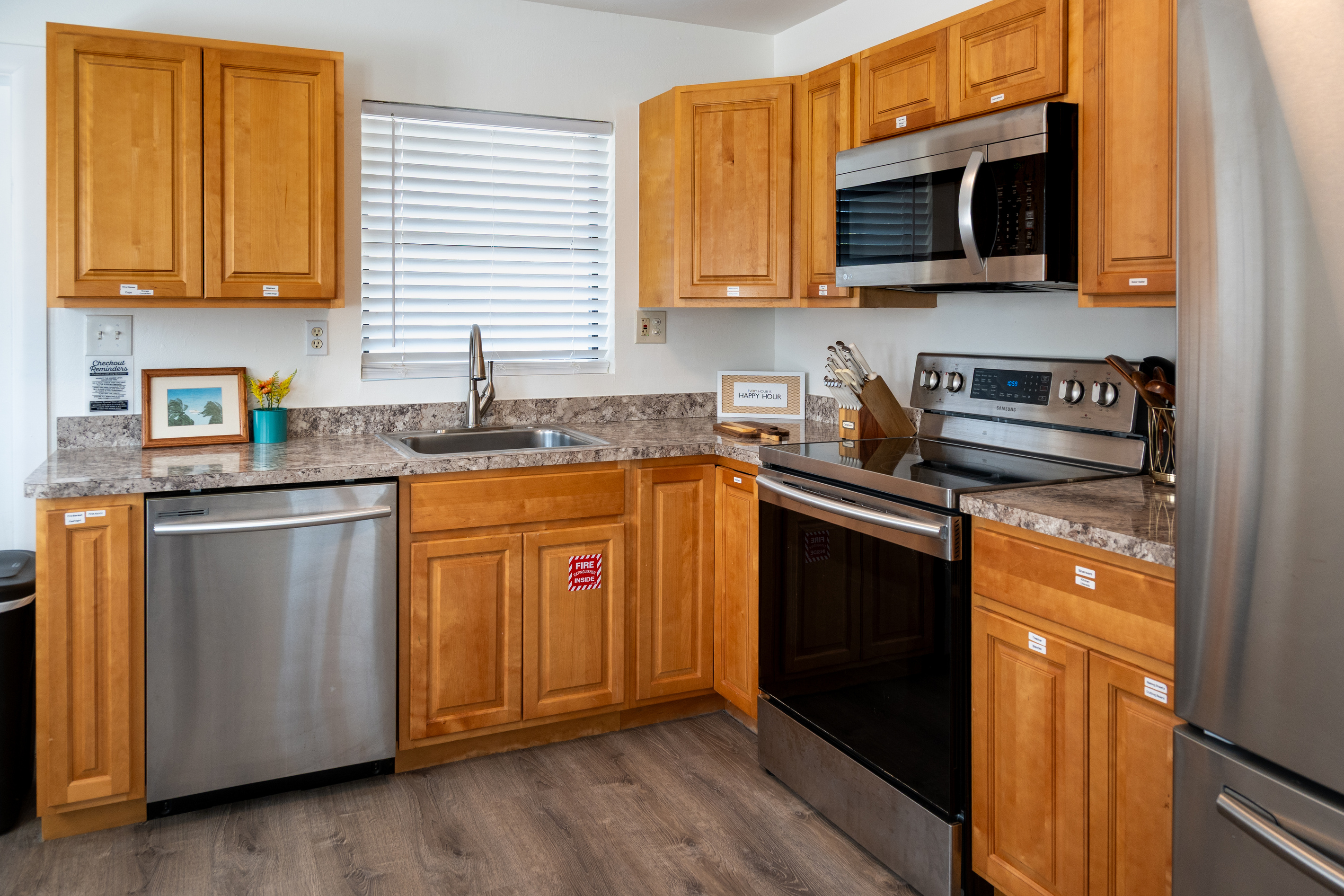 Full kitchen with stainless dishwasher, stove and microwave