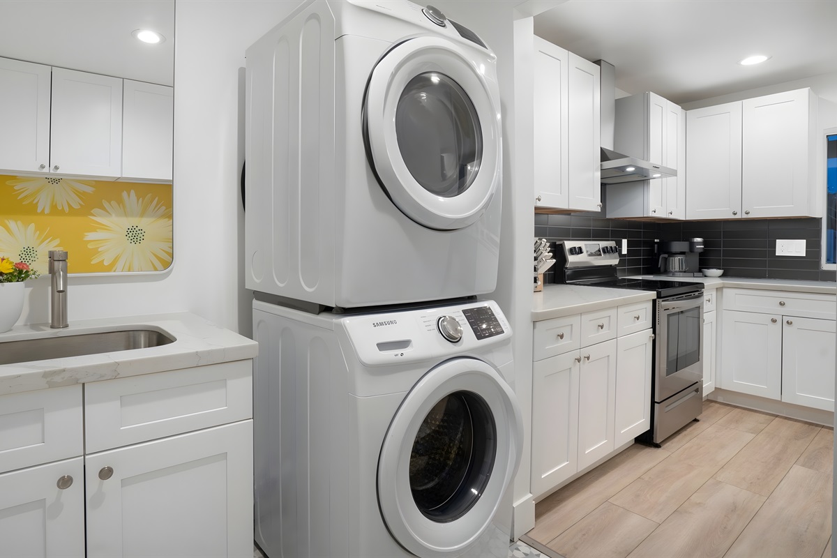 Laundry room with washer/dryer, sink, bench seating, and tons of storage