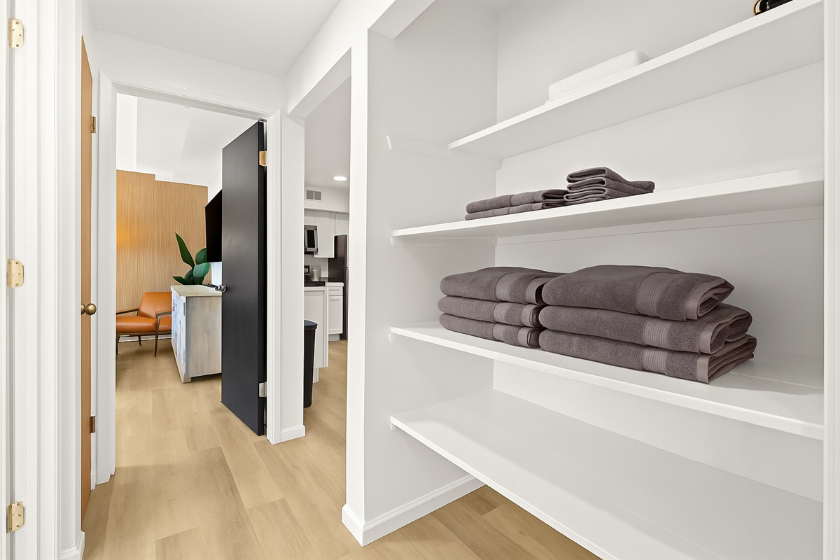 Fresh towels are fully stocked and easy to access from this convenient open-shelf linen nook.