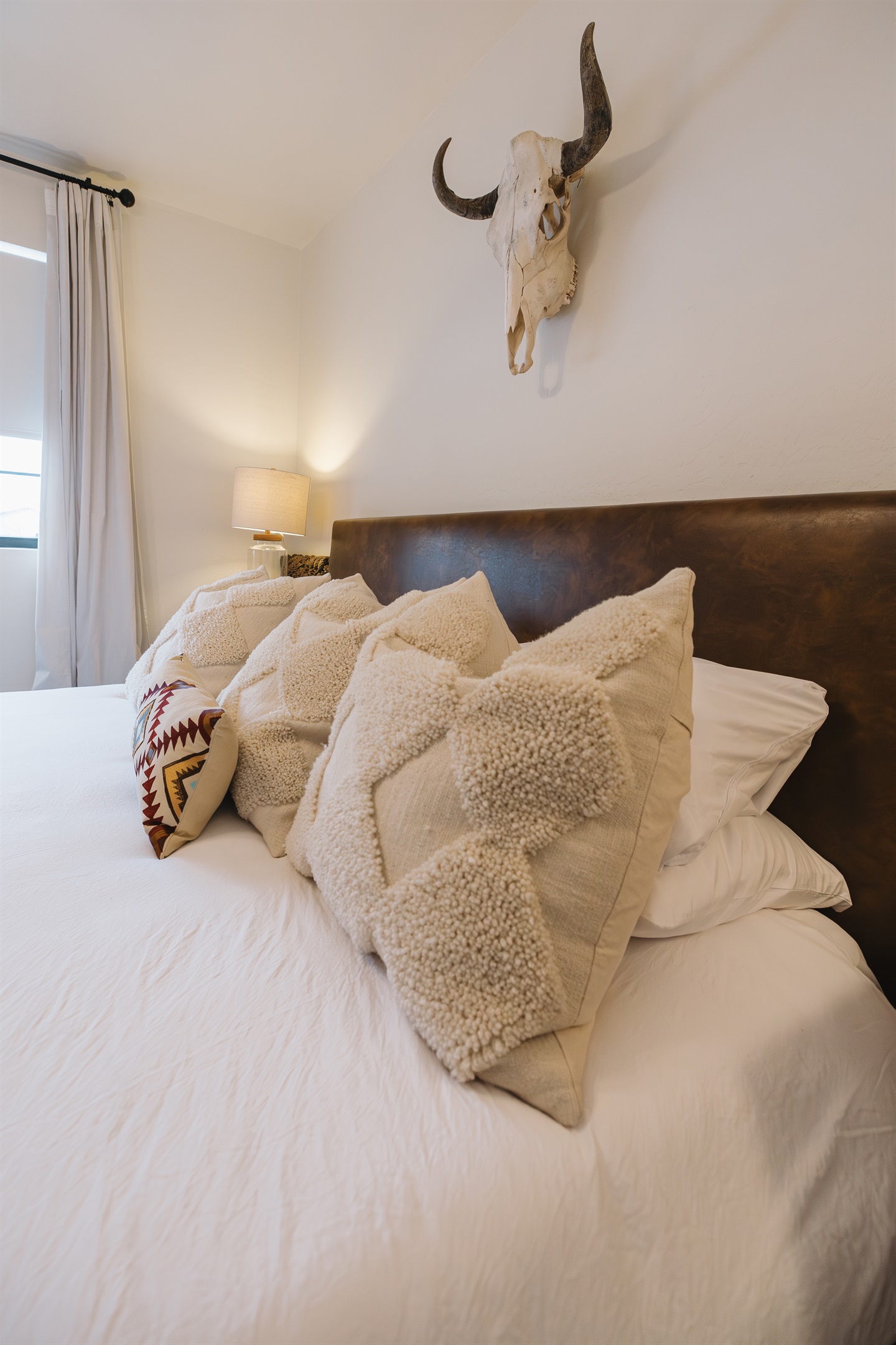 Plush king bed with cozy layers and warm mountain style—designed for restful nights and slow mornings. A romantic Pinetop retreat ideal for couples or families unwinding after outdoor adventures.