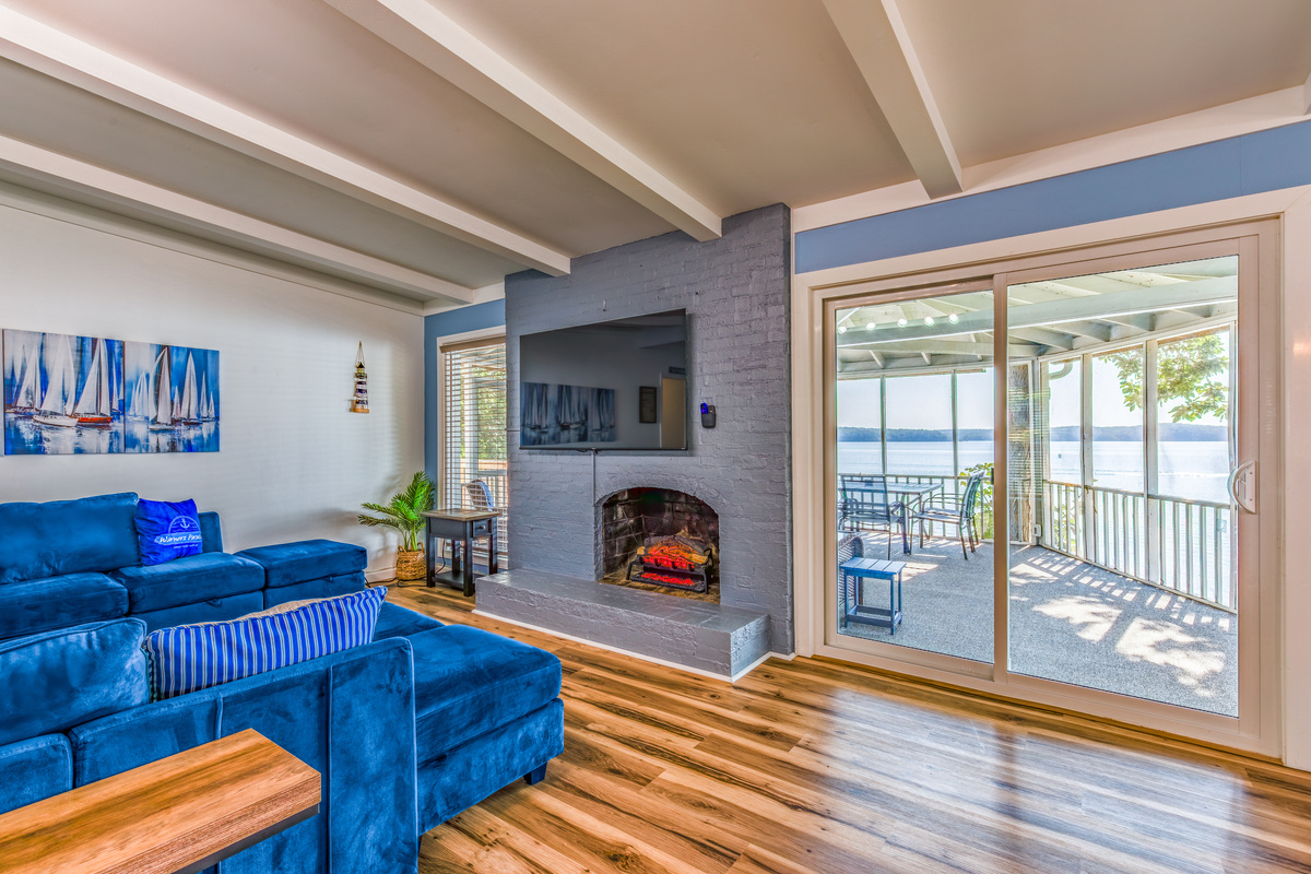 Sliding doors connect the living room to the screened porch and bring the lake view into the home.