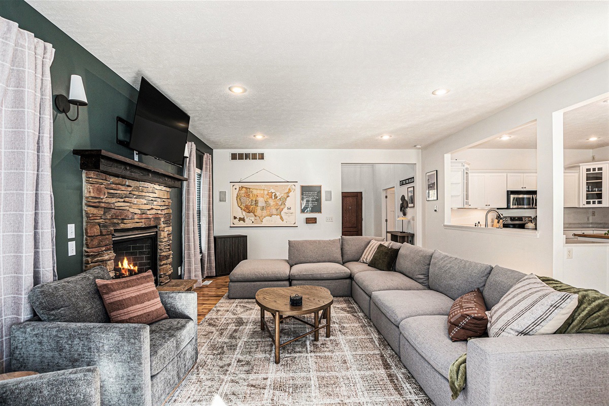 Cozy up around the fireplace—game nights, movie marathons, or morning coffee happen here.