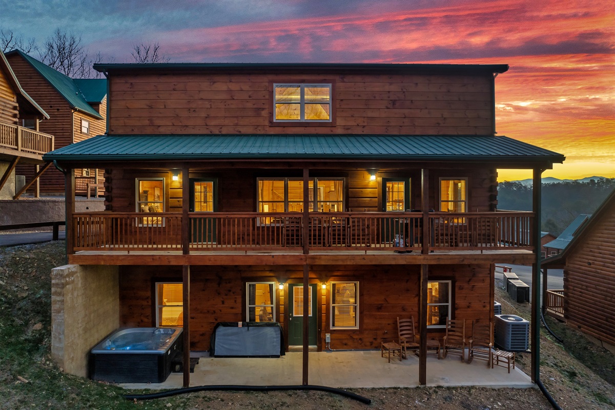 Back side with patio, balcony and hot tub.