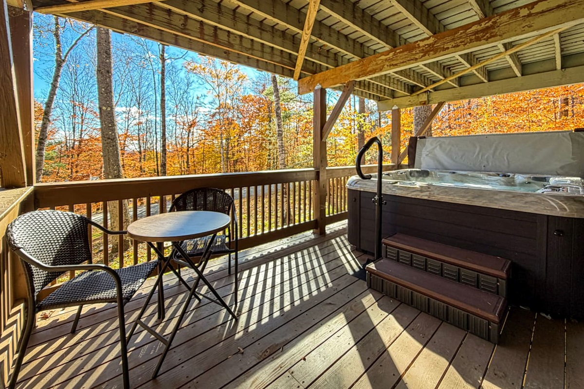 Lower deck with a hot tub and cafe table