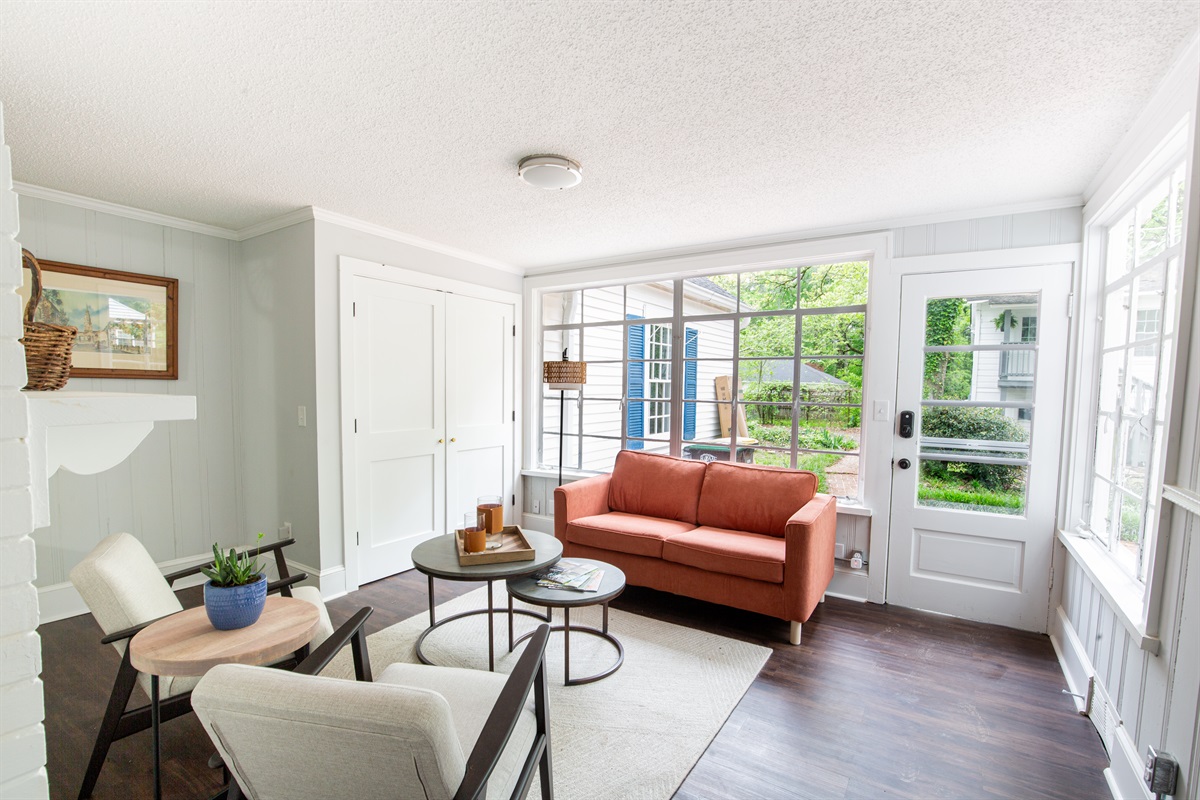 The sunroom boasts comfy seating and lots of natural sunlight!