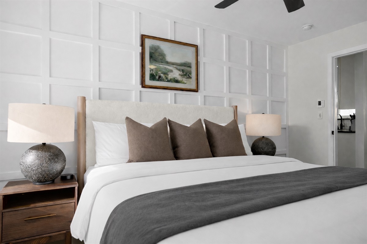 Elegant bedroom with plush king bed, soft lighting, and a stylish accent wall—offering a peaceful, hotel-like retreat for a great night’s sleep.