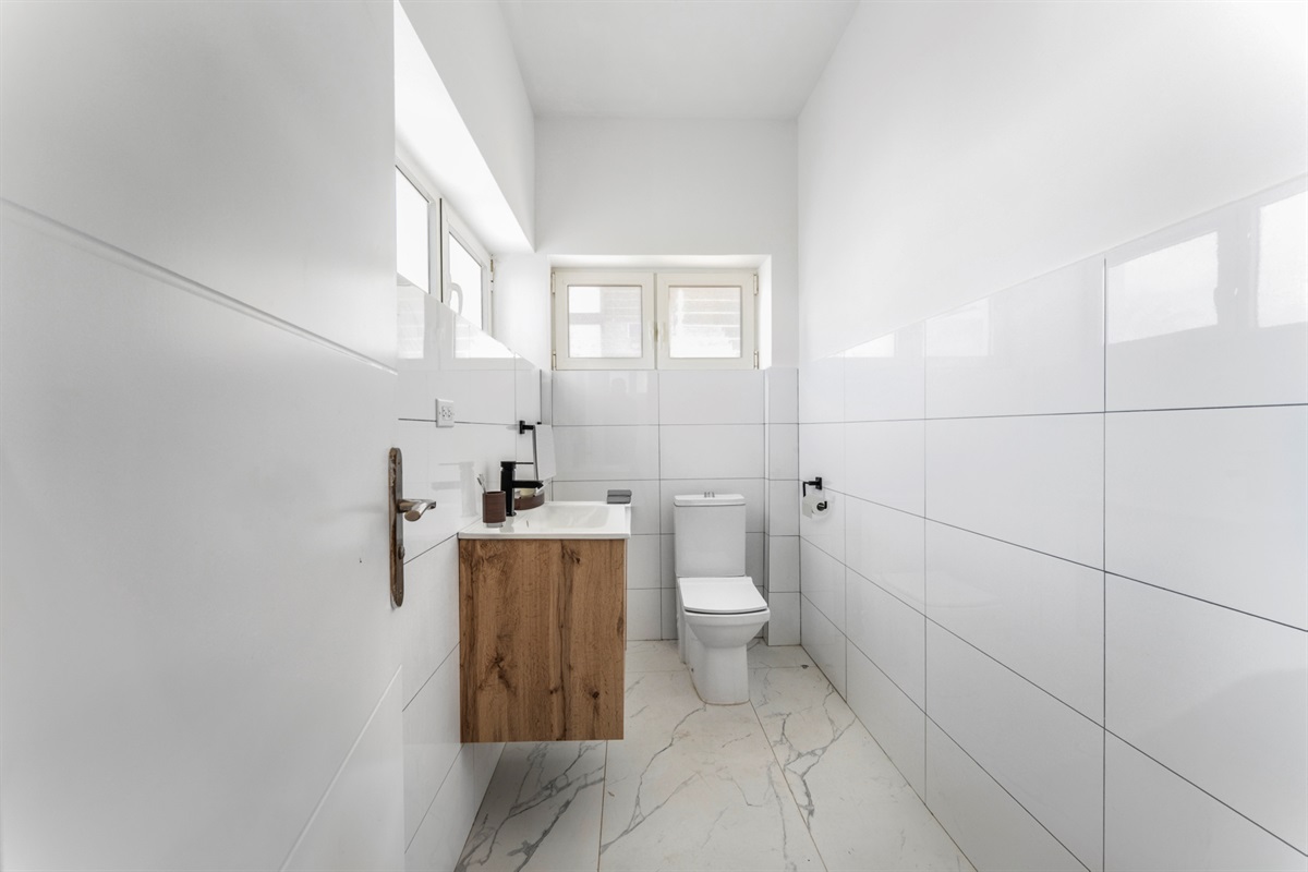 A pristine half-bath is conveniently located on the ground floor near the entryway