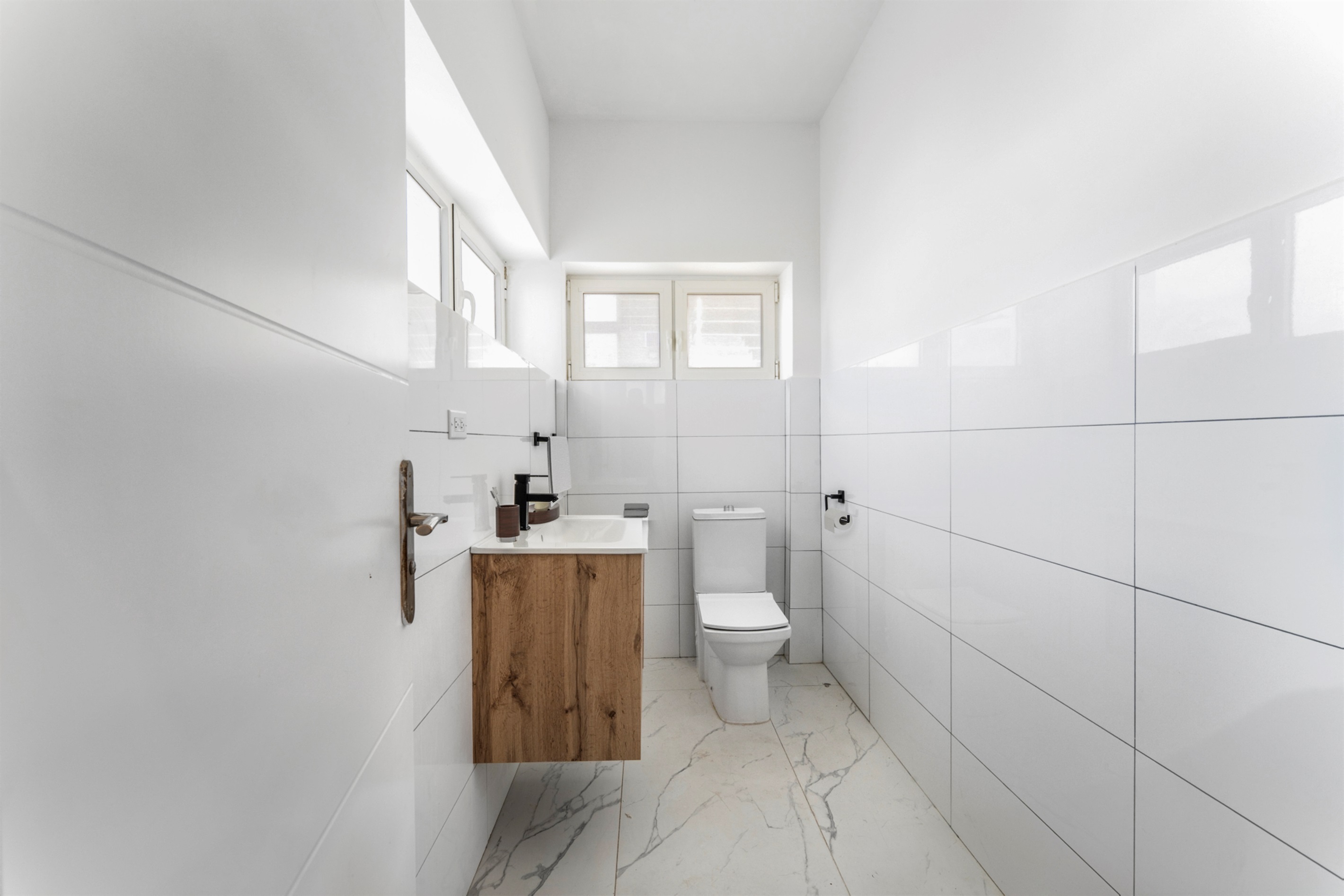 A pristine half-bath is conveniently located on the ground floor near the entryway