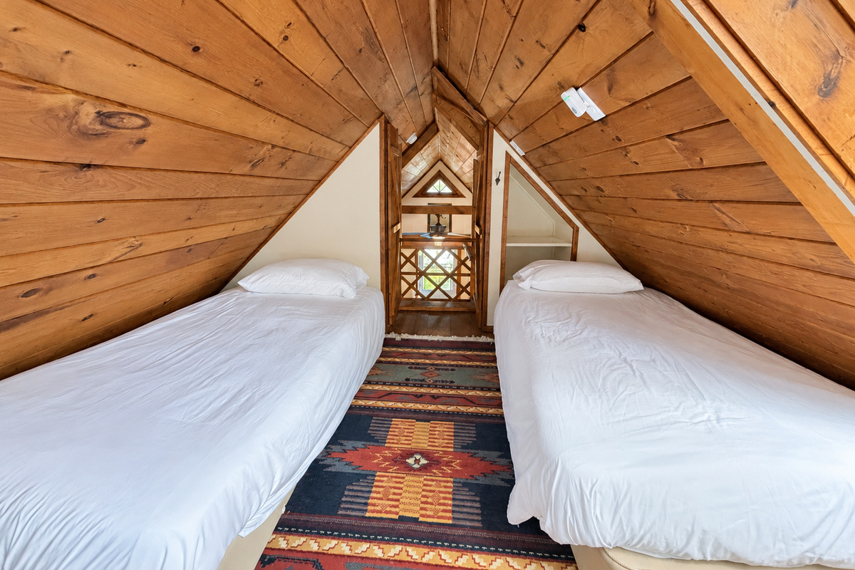 Upstairs sleeping loft with 2 twin beds and big skylight