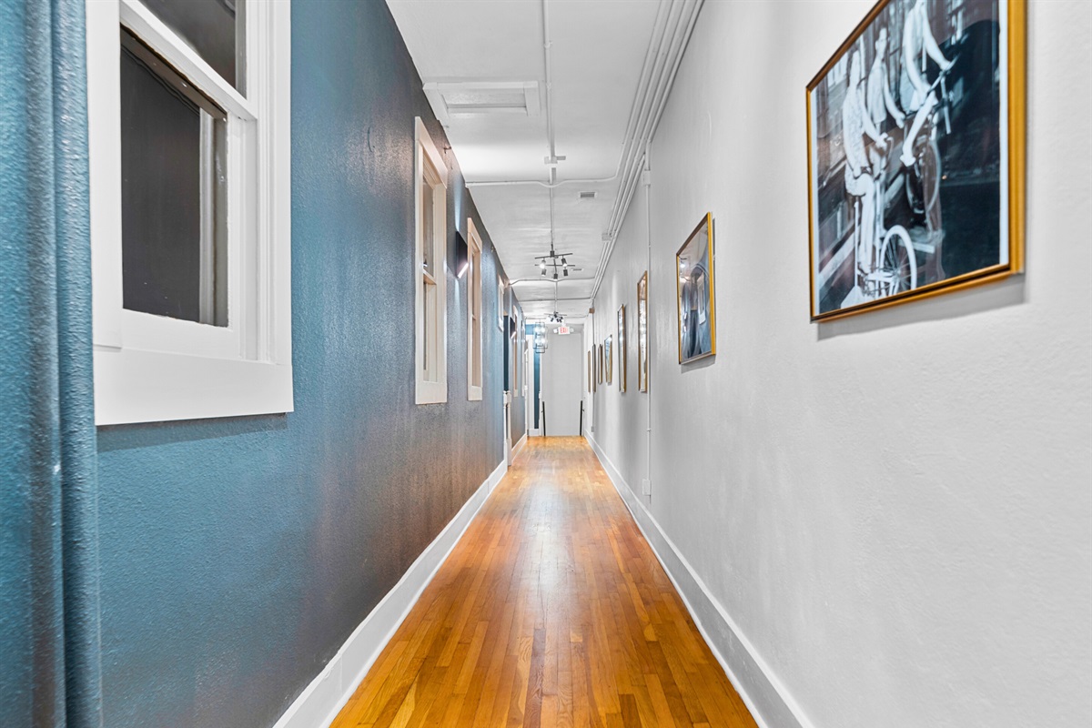 A stylish hallway within the building leads you to your cozy retreat, setting the tone with a mix of modern decor and historic charm.