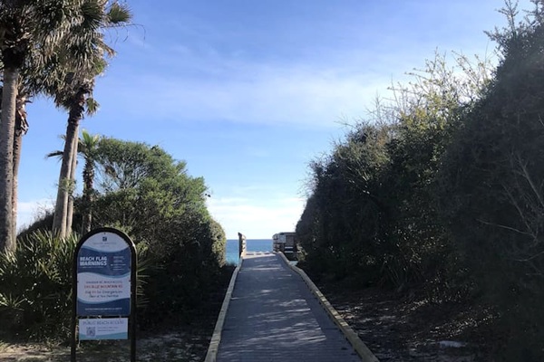 Discover a local secret!  A short stroll down Blue Mountain Rd leads to a more secluded public beach access. Enjoy a scenic coastal walkway lined with palms, leading to a quiet, peaceful stretch of sand—perfect for sunset walks.
