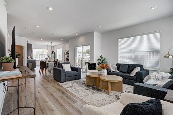 Enjoy a designed open-concept space with a modern kitchen equipped with quartz countertops, stainless steel appliances, and all essentials for home cooking. 