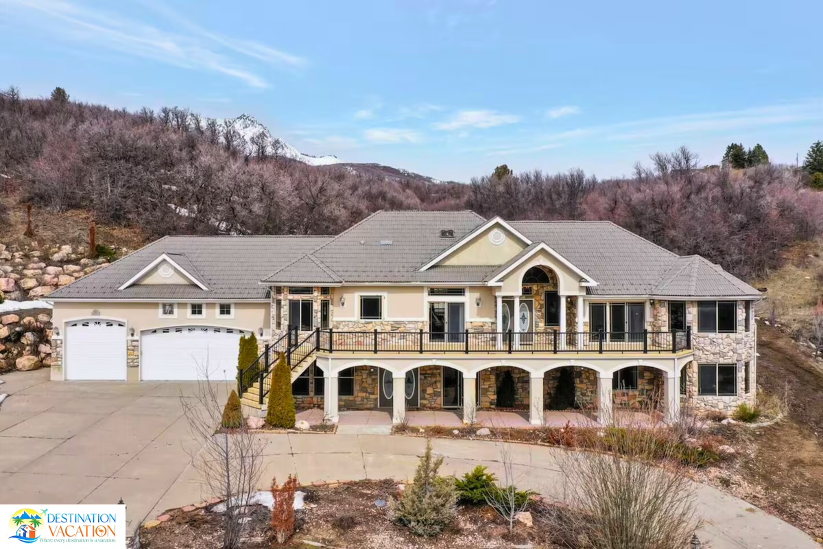 Grand mountain home nestled beneath stunning wooded slopes.