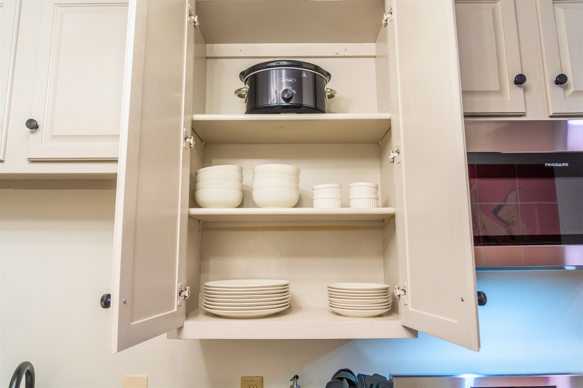 Shelves stocked with dishes and kitchenware are ready to make your dining experience as convenient and comfortable as possible.