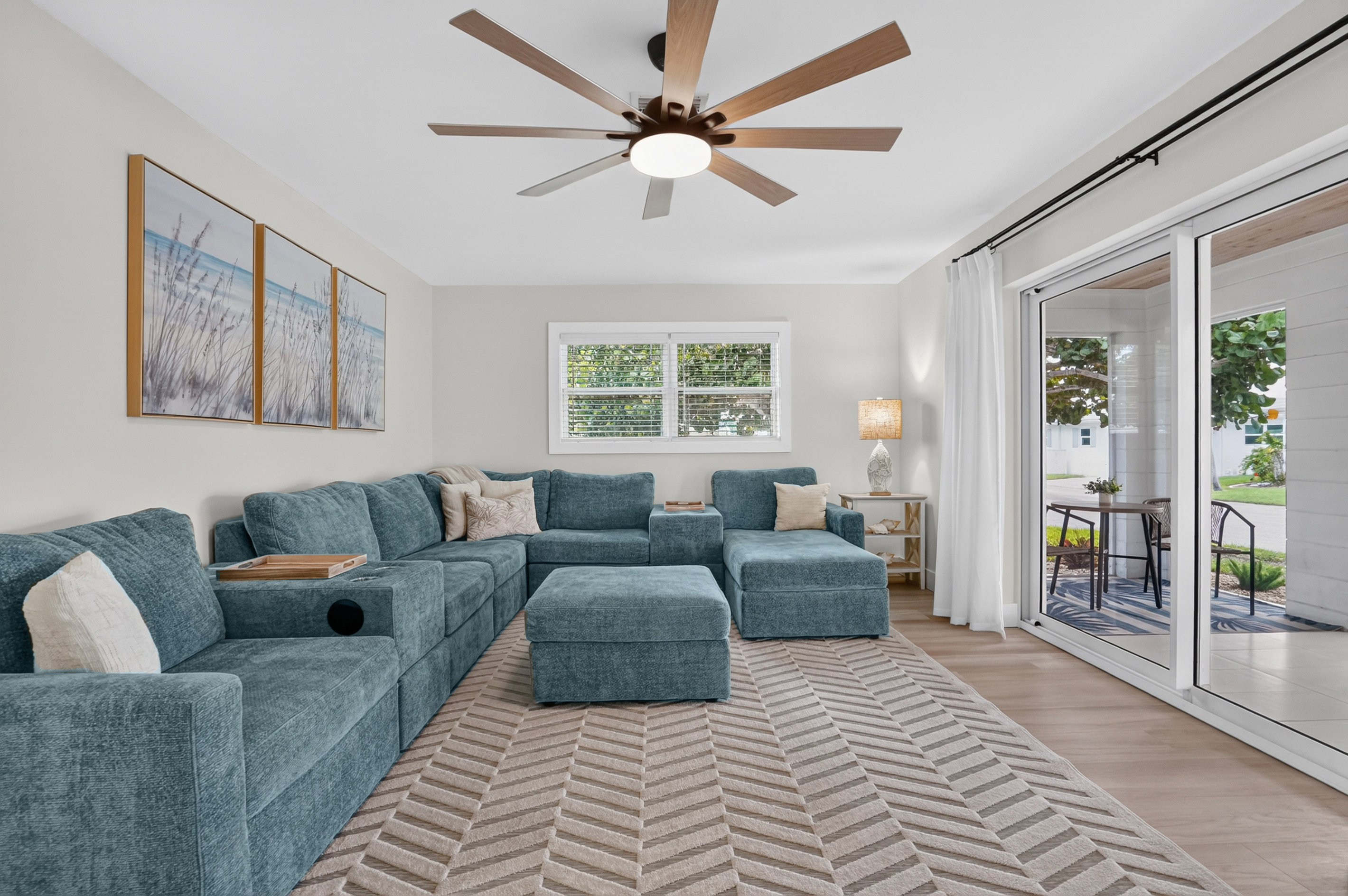 Sliding doors connect the spacious living room to the screened lanai and invite in plenty of natural light.