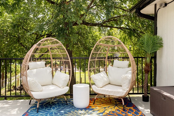 Relax in comfy egg chairs amidst lush greenery and vibrant decor!