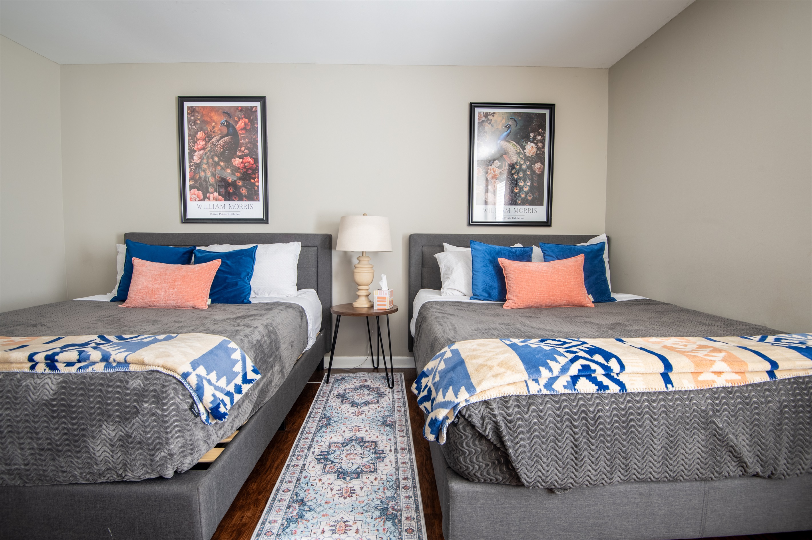 The double queen bedroom on the left in Unit B is thoughtfully designed for coziness and the best streaming nights!
