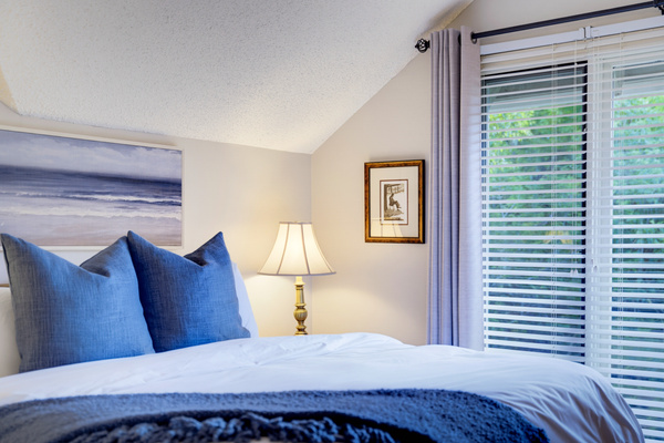 Wake up surrounded by treetop views and natural light from the primary bedroom’s oversized windows.