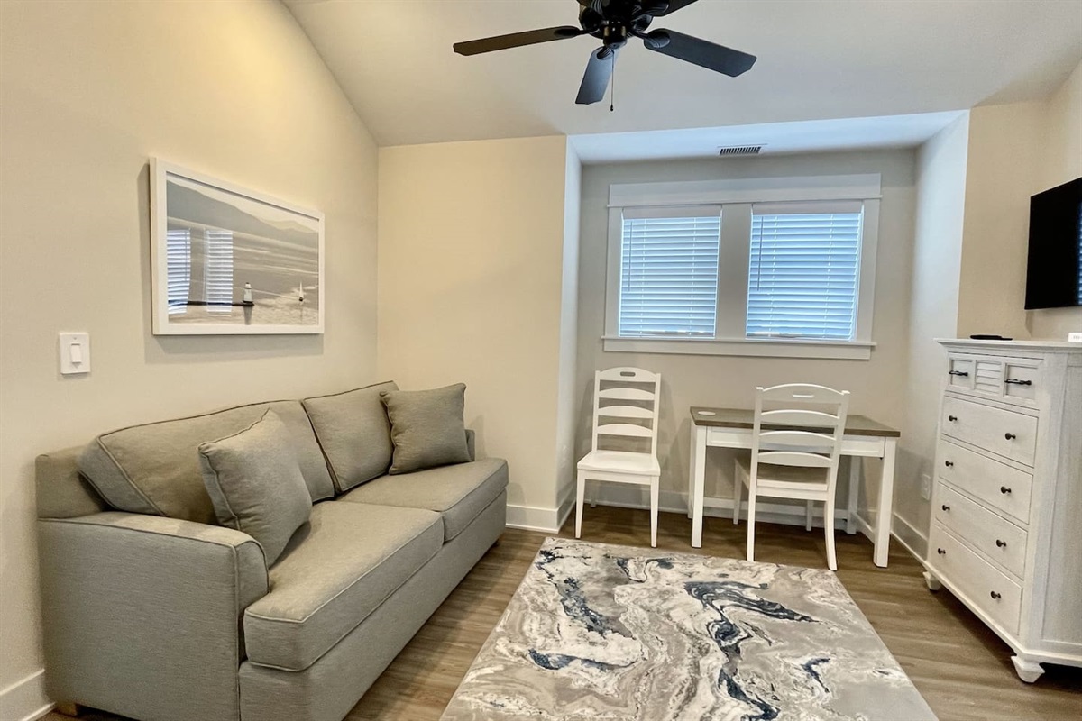 A quiet corner to get some work done. The den features a desk, two chairs, and a dresser for added storage