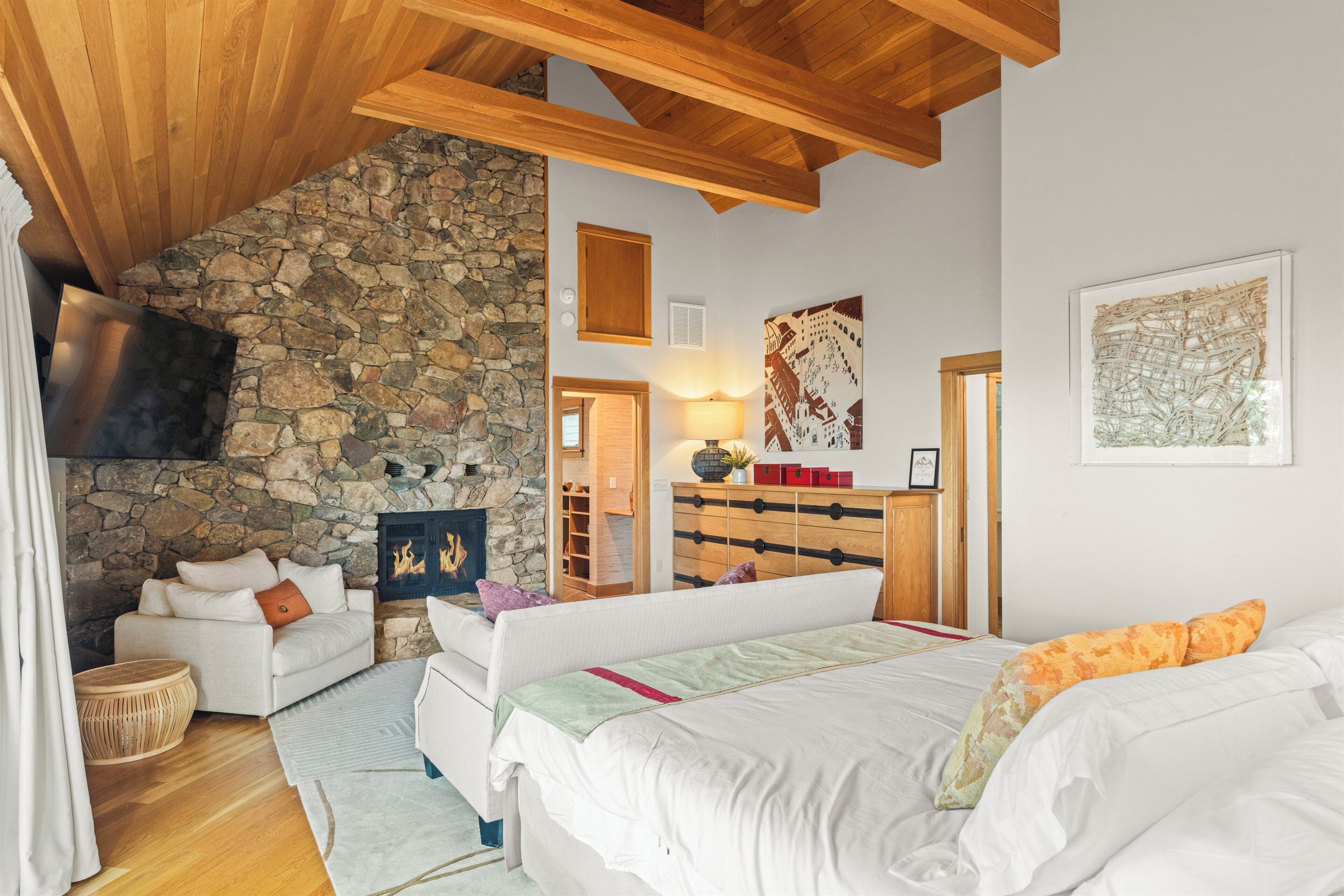 BR1: Primary bedroom on main level with king bed, seating area, gas fireplace
