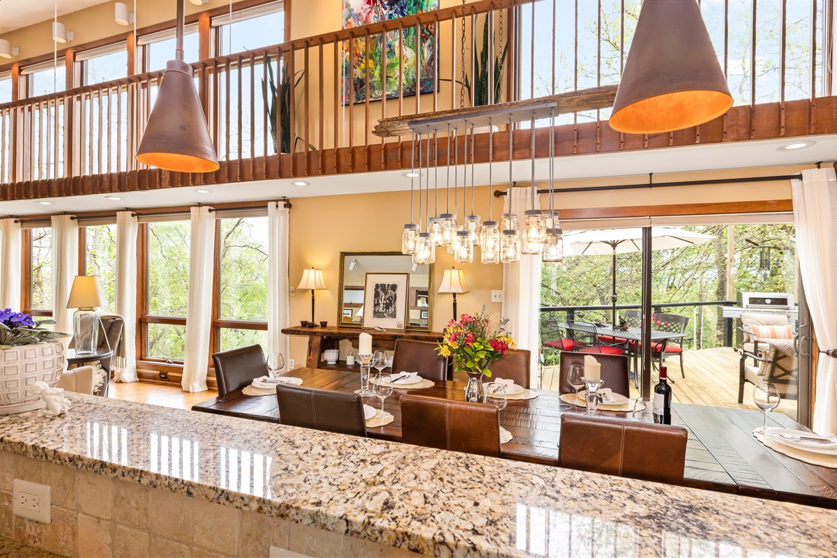 Views of dining area, beautiful window view, catwalk above, and deck to the right. So many options for having fun and relaxing!