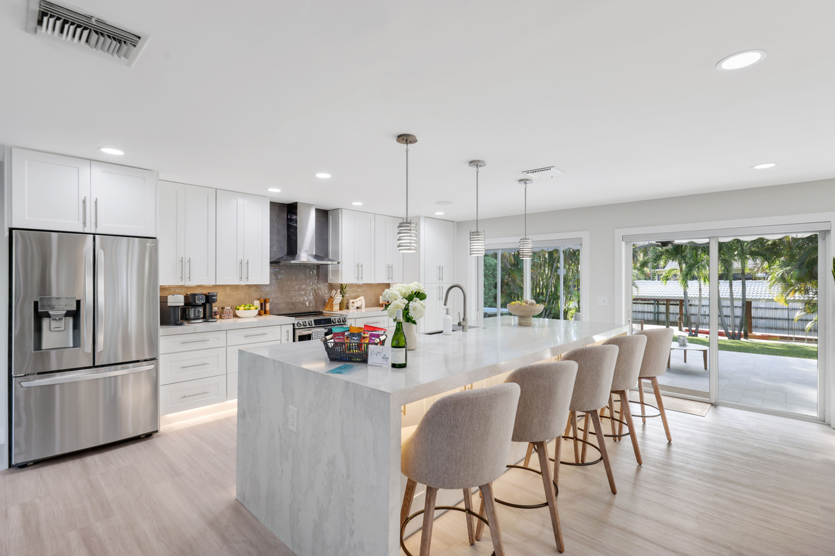 Gather around the island for coffee, snacks, or casual meals while the sliding doors keep the patio and pool within easy reach.