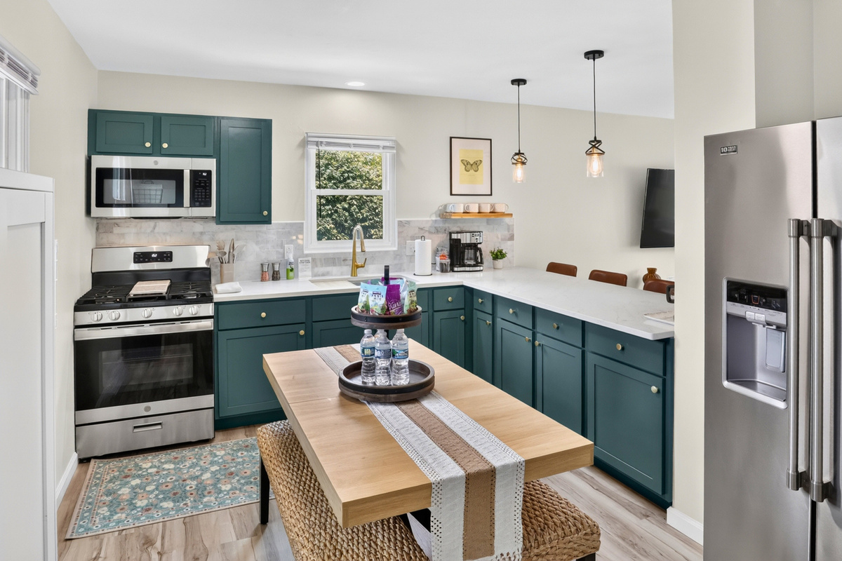Fully stocked eat in kitchen with additional bar stool seating and gas range.