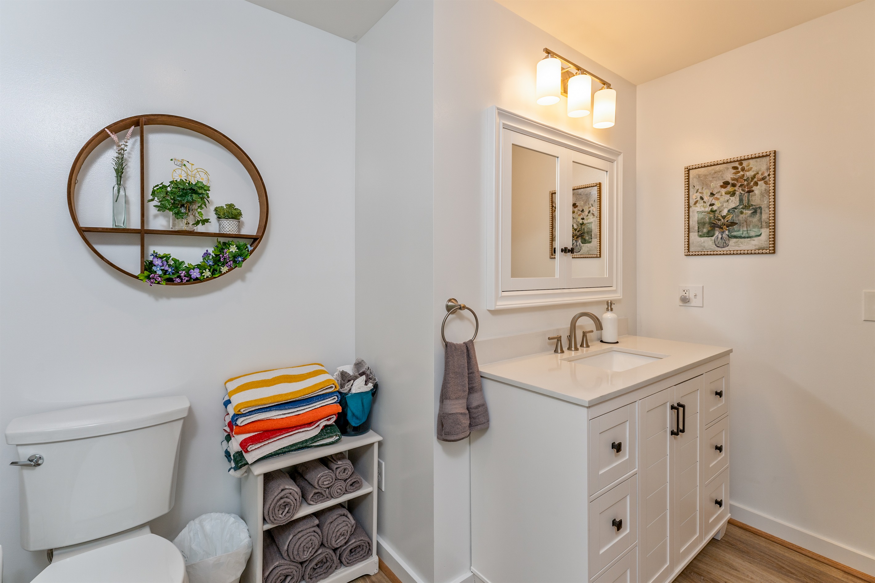 Bright and modern bathroom with a sleek vanity, stylish fixtures, and natural light pouring in from the window.