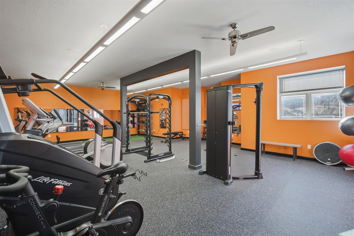 The onsite gym features commercial-grade cardio and strength equipment, rubber flooring, ceiling fans, and energizing natural light—perfect for maintaining your workout routine.