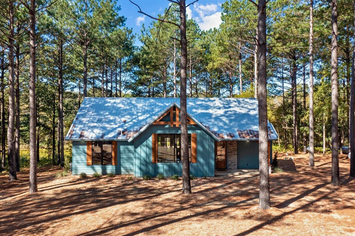 Welcome to your forest hideaway, where the cabin charm blends with the trees.