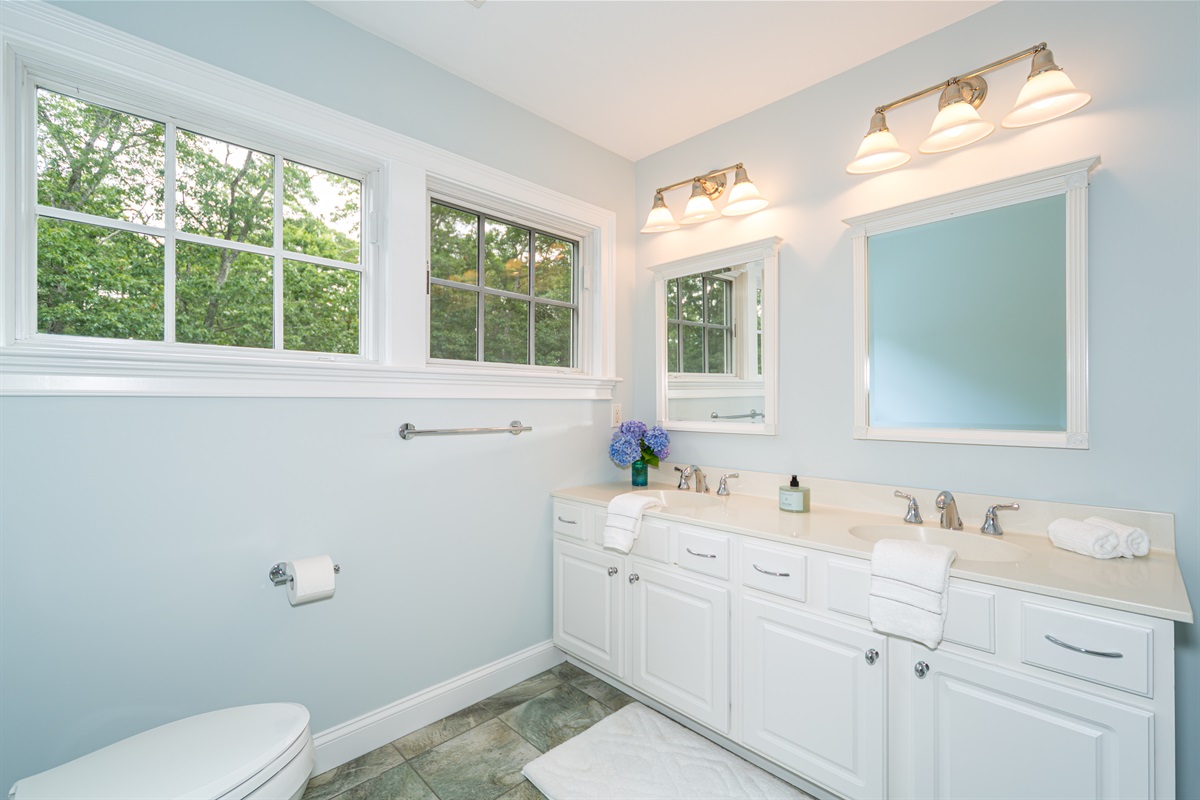 Upper-level shared bathroom with a full tub