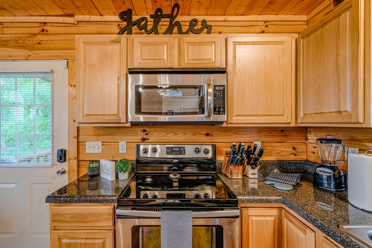 Fully stocked kitchen with pots, pans, rice cooker, blender, toaster, drip and kureg coffee machines.