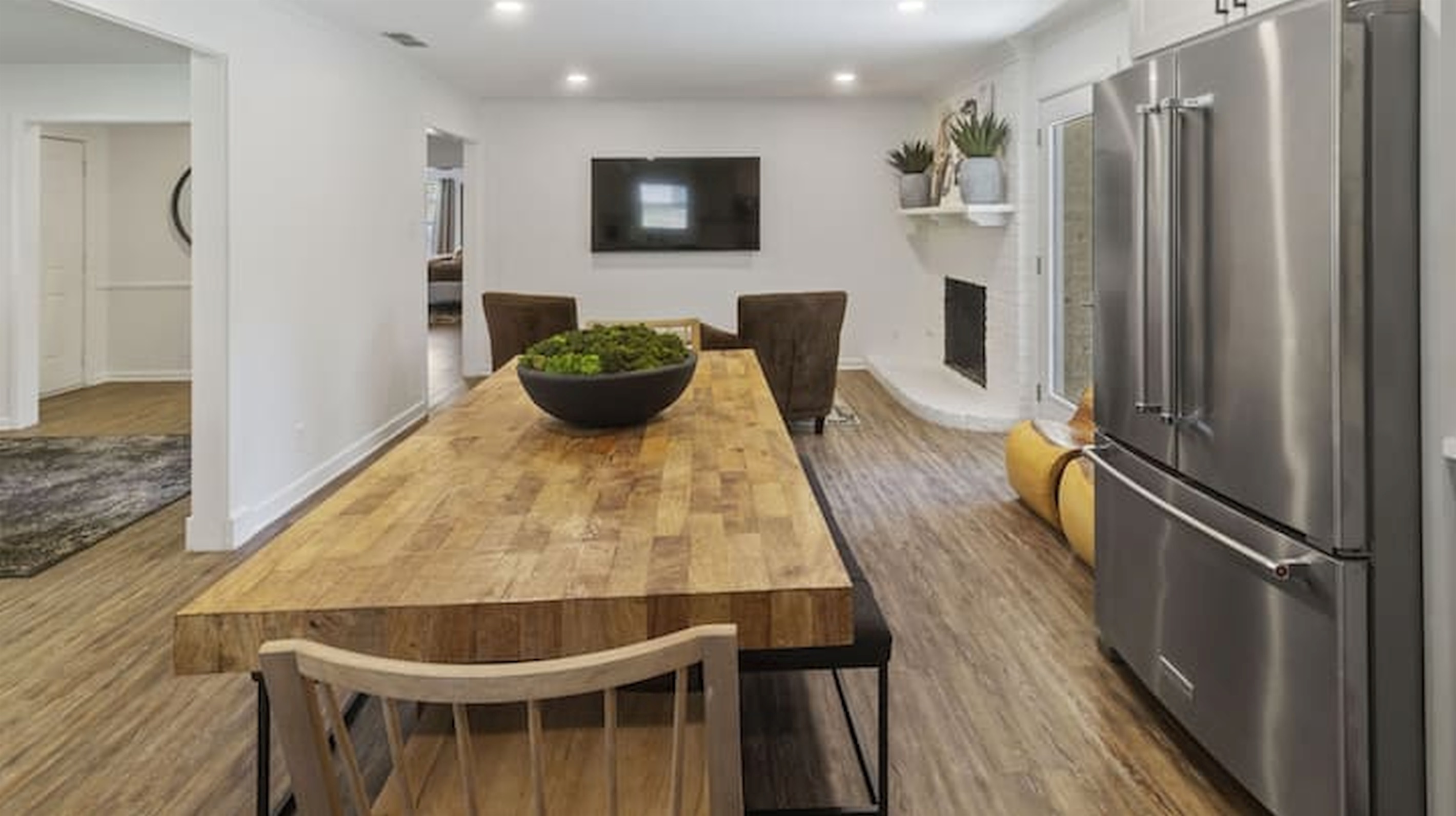 Bright open-concept layout connecting the kitchen, dining, and living spaces seamlessly.