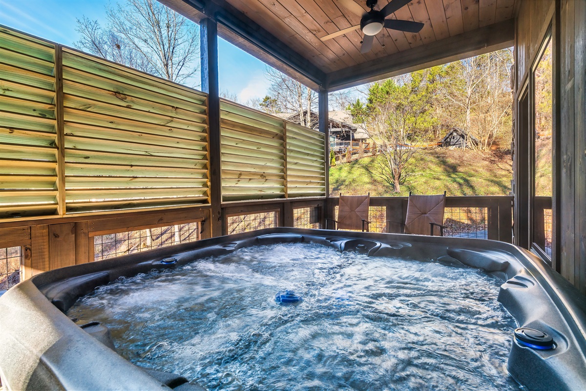 Hot tub on the lower deck and roller shades and privacy screens