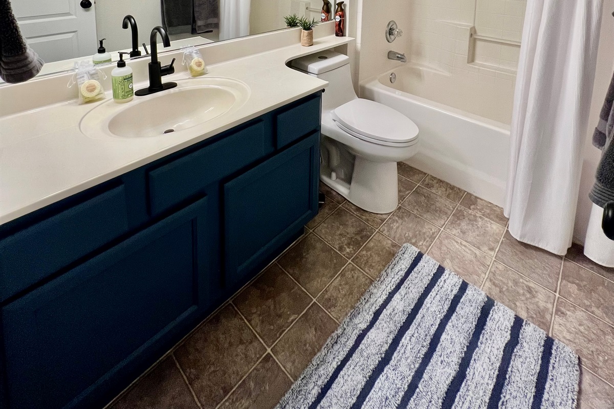 The secondary bathroom features a convenient shower/tub combination and ample counter space, ensuring comfort and functionality for all guests.