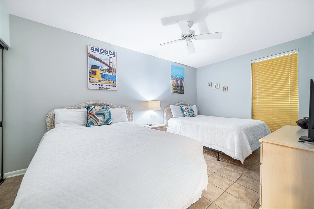 A versatile bedroom featuring two twin beds, ideal for families or friends traveling together, with a comfortable and welcoming atmosphere.