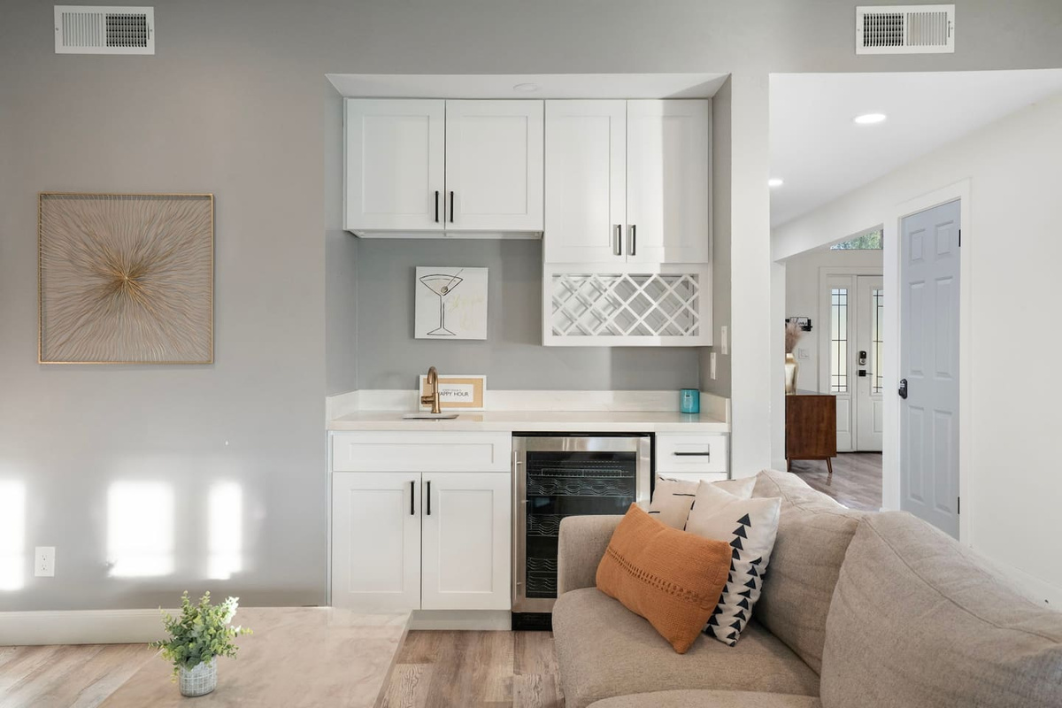 Living room with bar and wine fridge.
