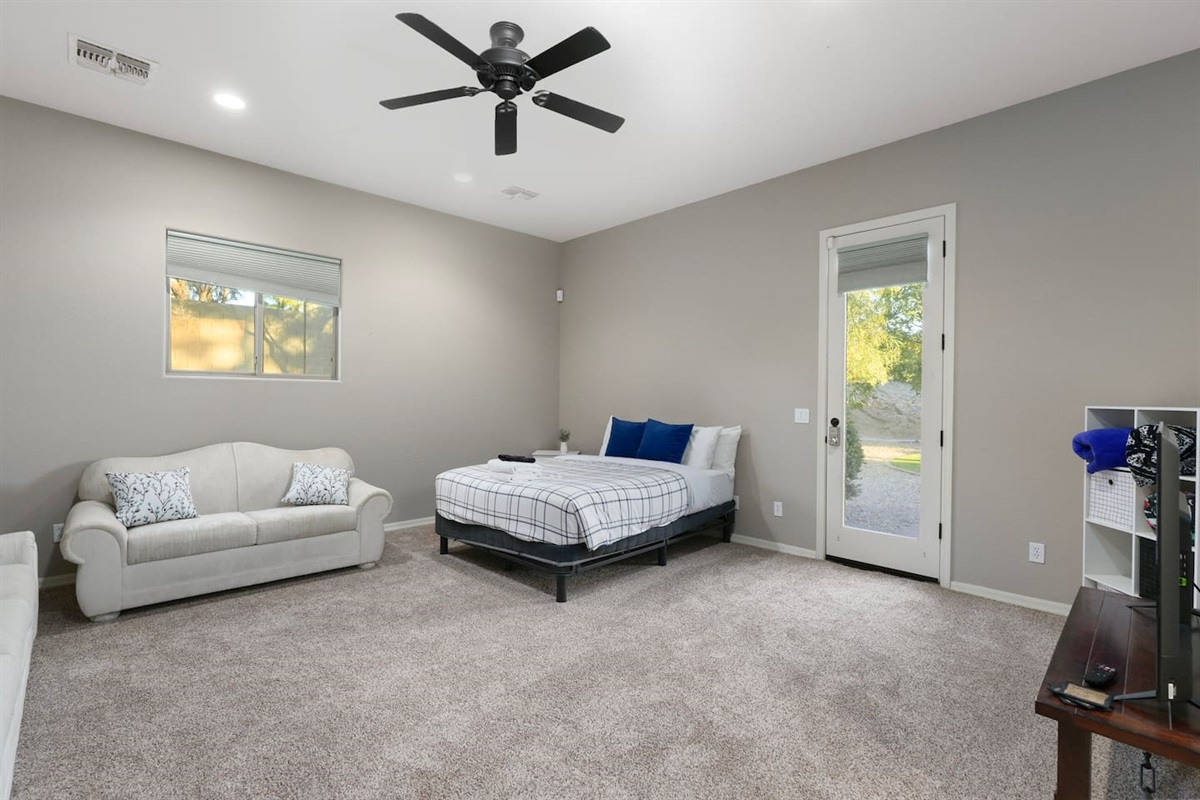 Wide view of the private casita with queen bed, seating area, and separate entrance.