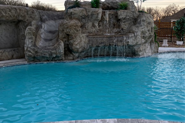 Resort style 30,000-gallon saltwater pool with double waterfalls and grotto and slide