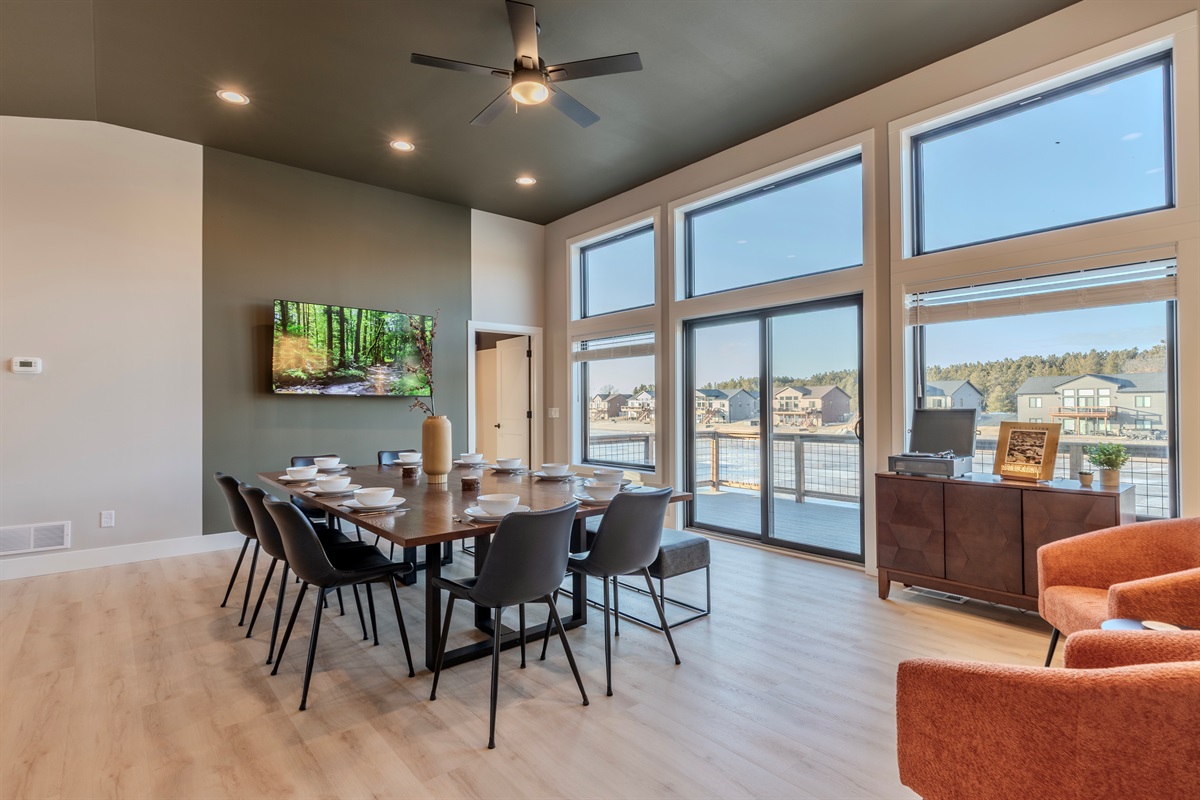 Open kitchen/dining upstairs area to gather in and listen to our bluetooth vinyl record player while overlooking the man made lake.