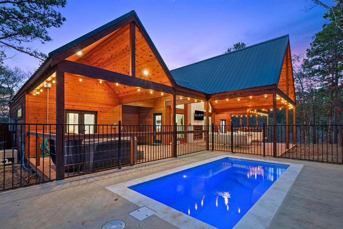 As evening settles in, the glow from the cabin reflects beautifully across the private pool, creating a peaceful spot where you can unwind with a swim or simply relax by the water.