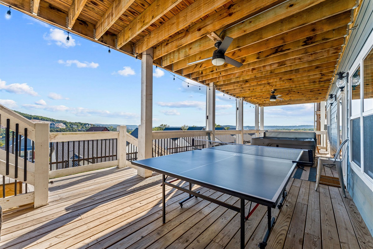 Outdoor ping pong table next to the hot tub!