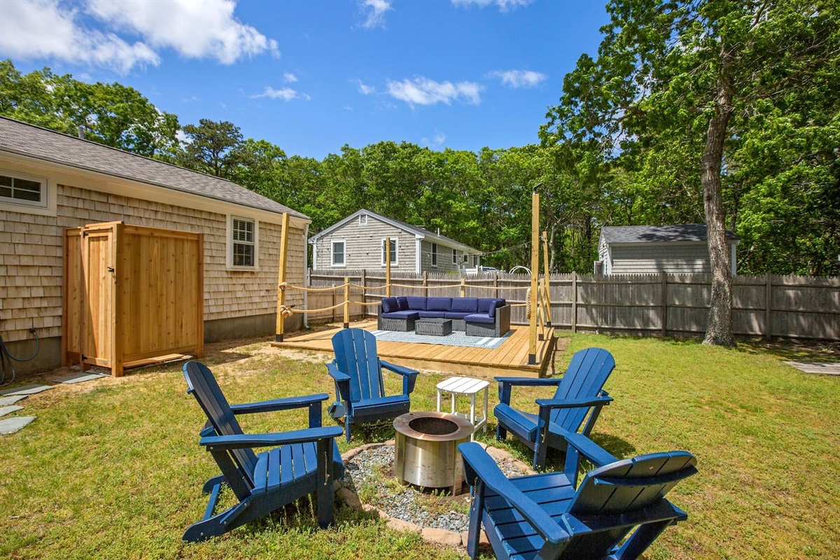 Unwind in the private backyard oasis featuring a cozy fire pit, spacious outdoor seating, and a refreshing outdoor shower—perfect for sunny days and starry nights.Unwind in the private backyard oasis featuring a cozy fire pit, spacious outdoor sea
