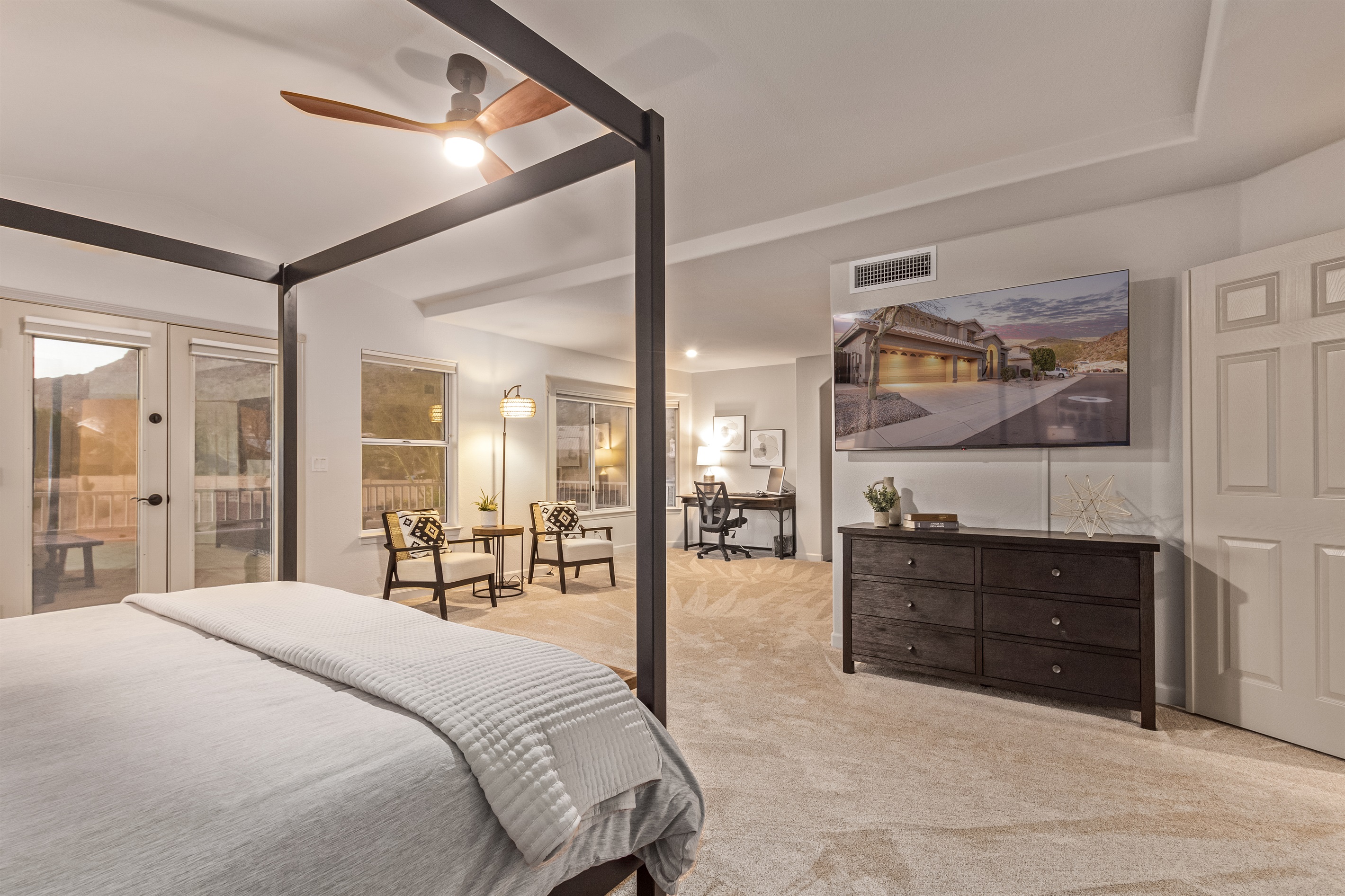 Extra large primary bedroom with king bed, 65" TV, walk in closet, sitting area, remote workspace, private deck, ensuite bathroom, linens and extra pillows and blankets.