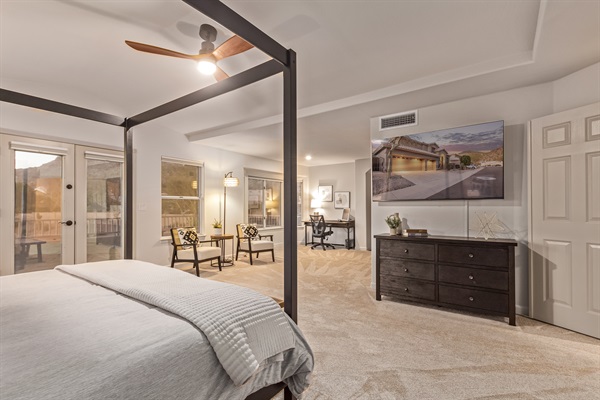 Extra large primary bedroom with king bed, 65" TV, walk in closet, sitting area, remote workspace, private deck, ensuite bathroom, linens and extra pillows and blankets.