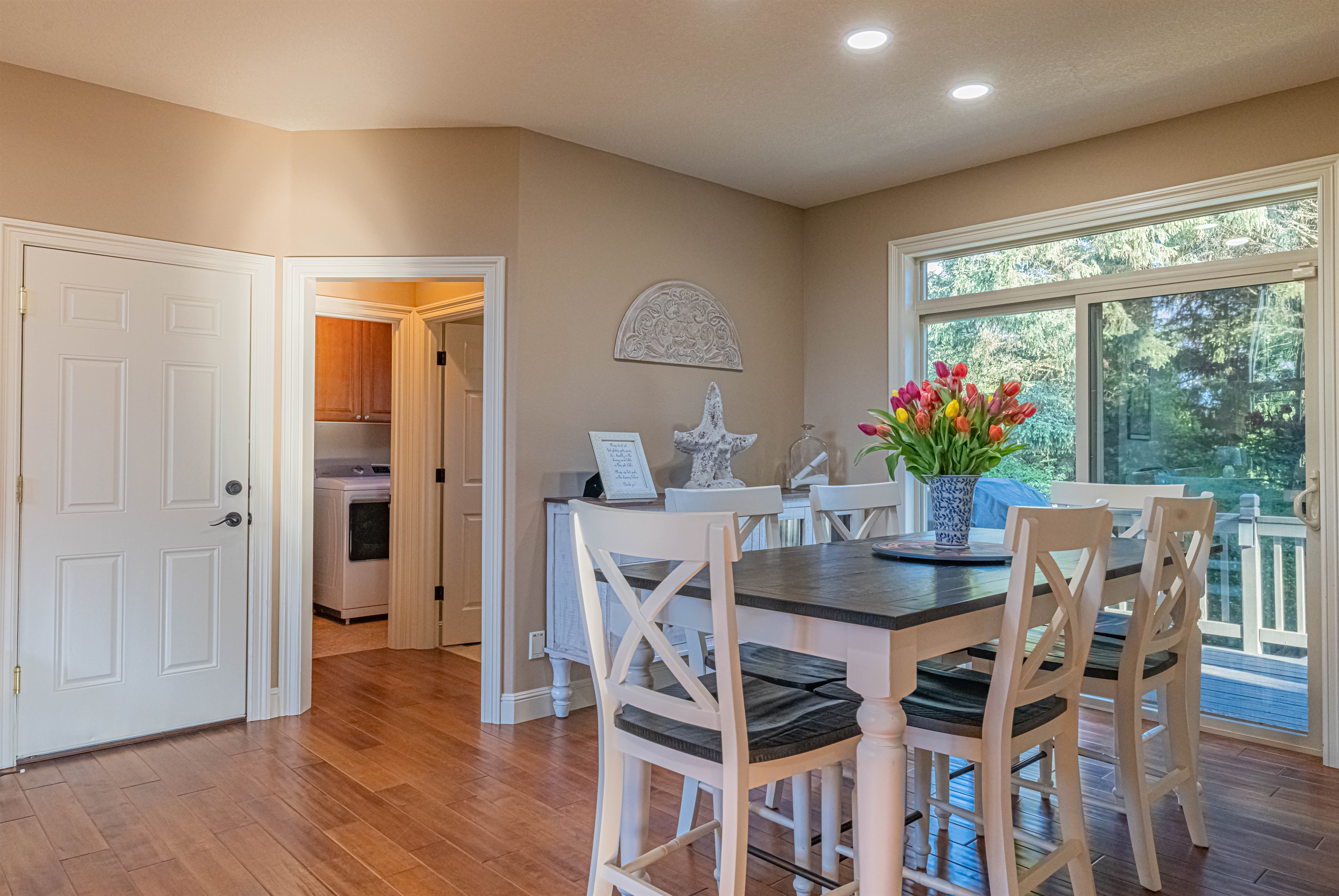 Dining room with seating for 6 and sliding glass door leading out to back deck.
