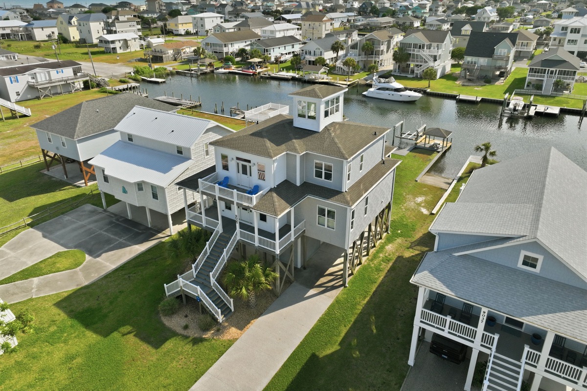 Stunning aerial view of this canal-front retreat just moments from the beach