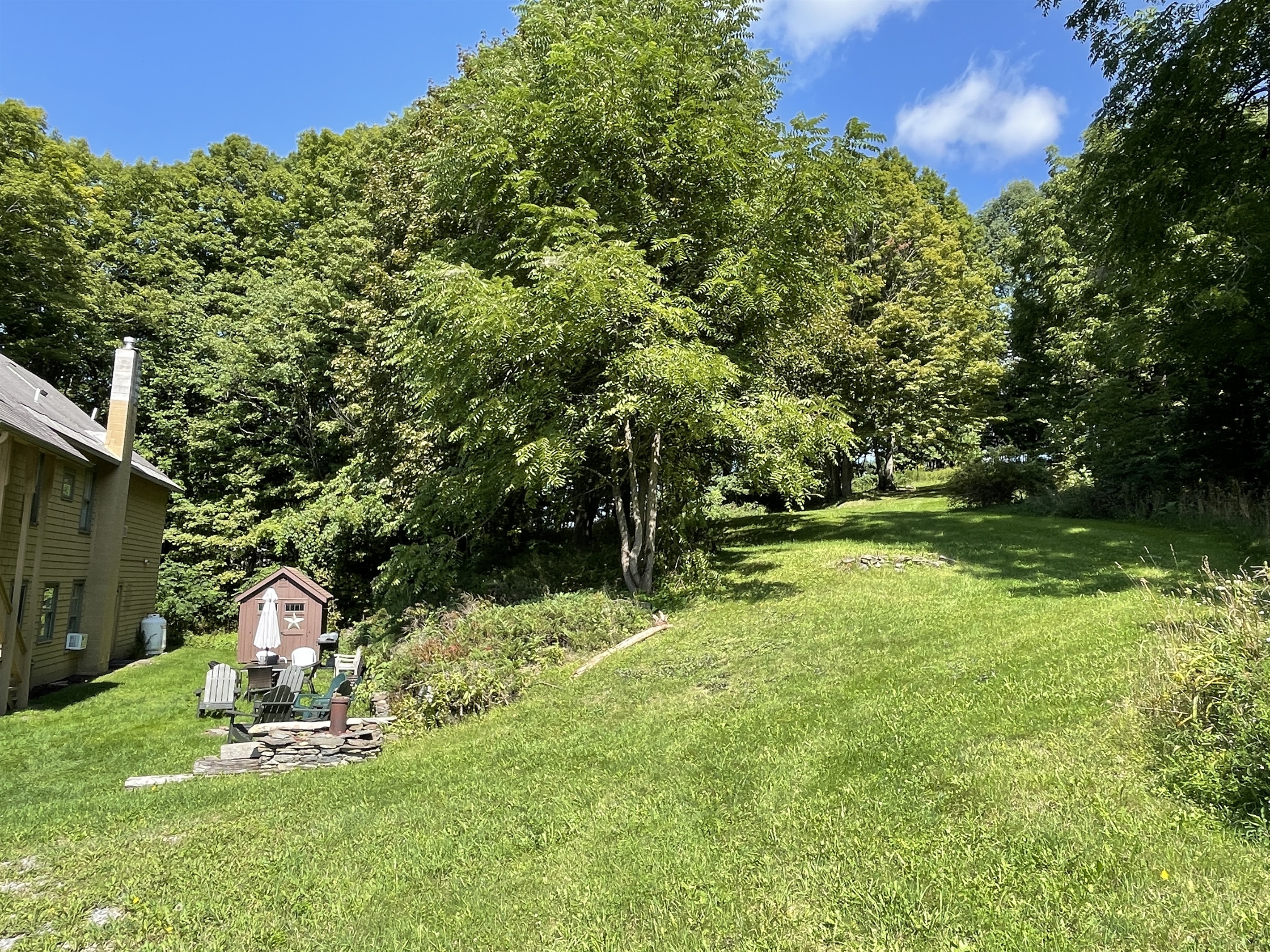 Side lawn leading to additional acreage you can explore.