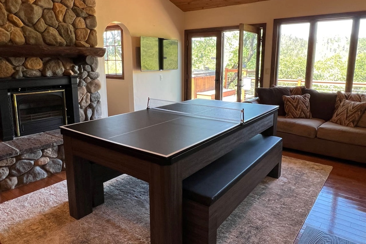 Second Living Room with a pool table, ping pong table topper, fireplace, surround speaker system, 4K TV, fireplace, and access to the back deck.